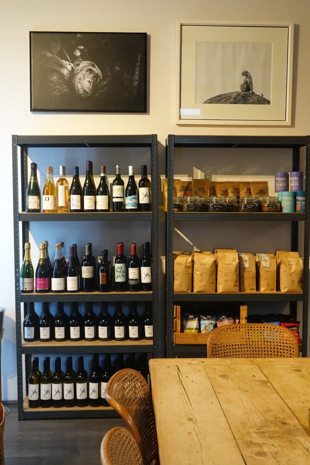 Wine display with bottles on shelves and a lit fridge