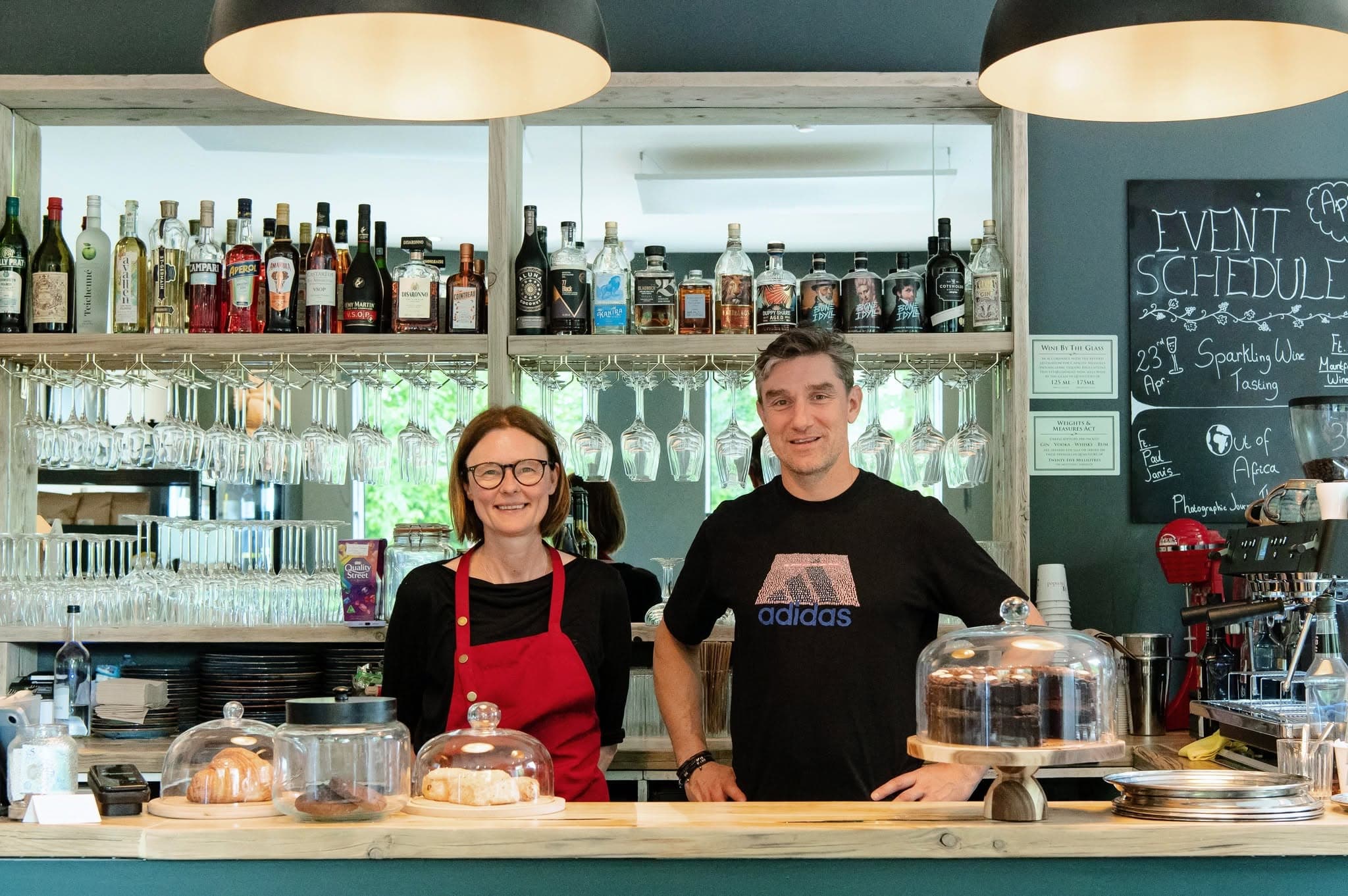 The Blended team behind the bar beneath the event schedule chalkboard