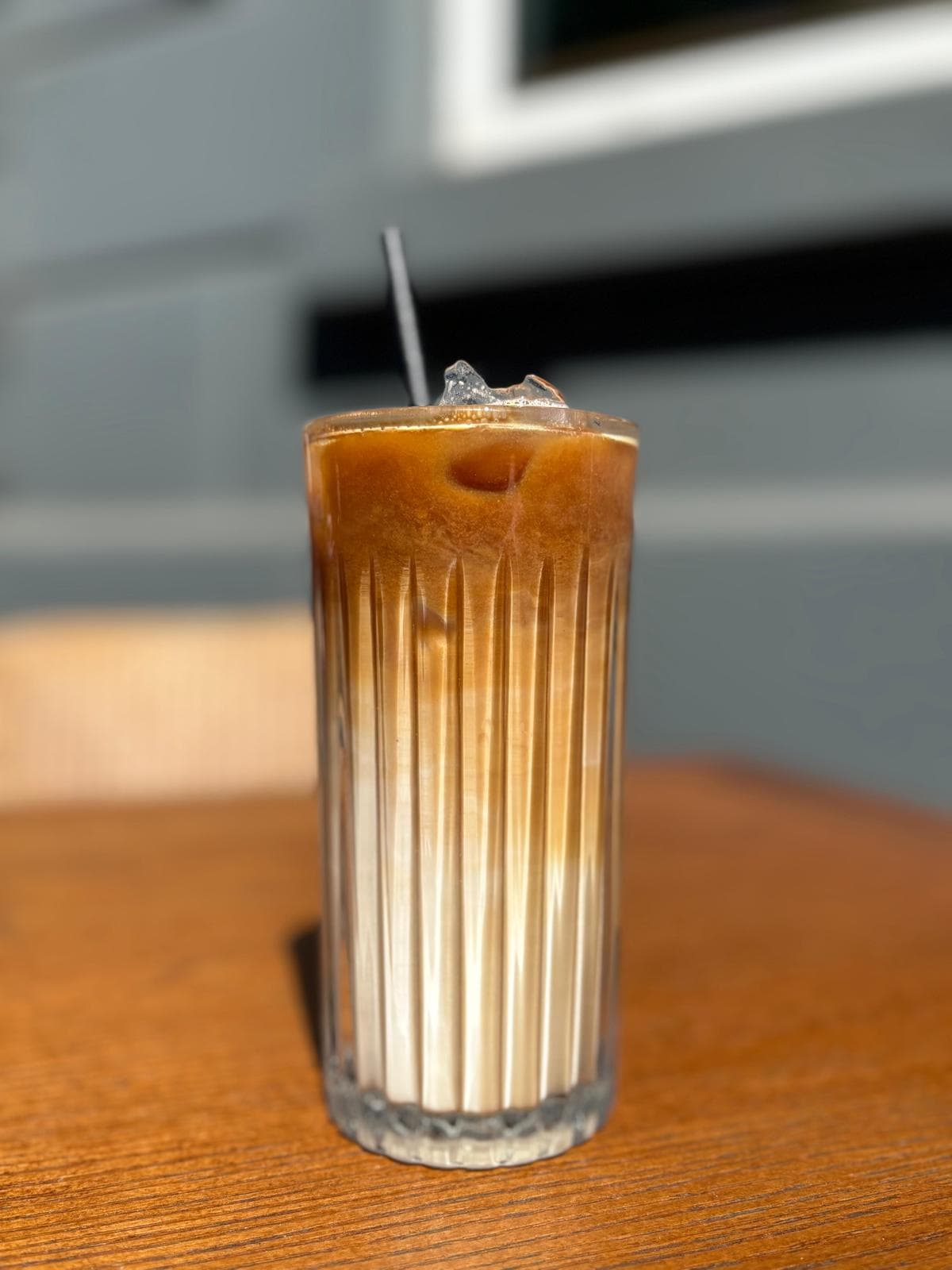 An iced latte served in a fluted glass at Blended